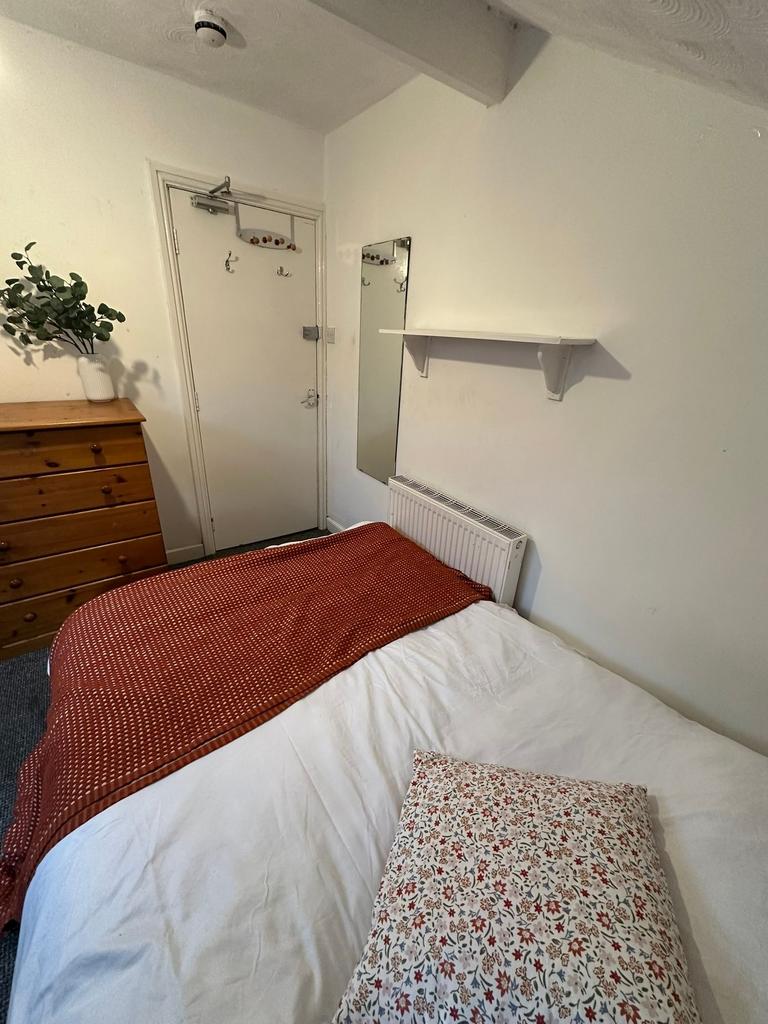 A cozy double bedroom featuring a neatly made b...