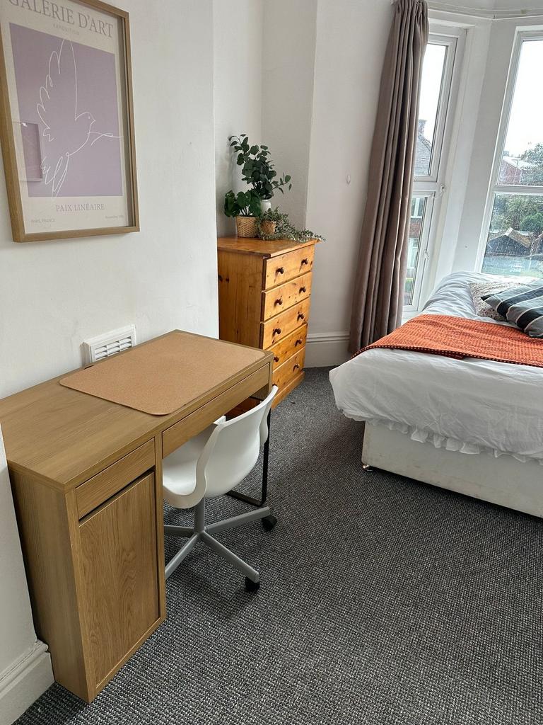 A cozy, well-maintained bedroom featuring a com...