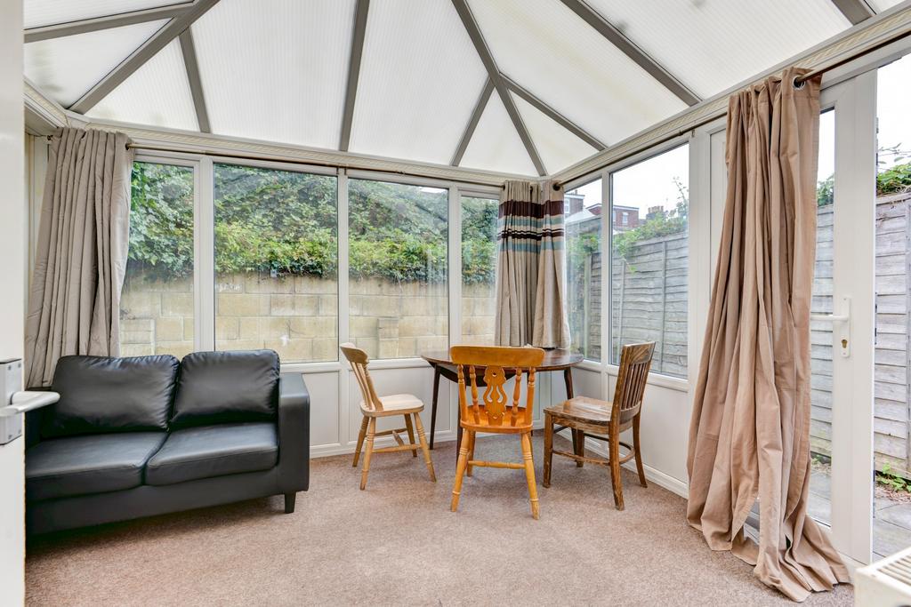 Bright conservatory-style living area with larg...