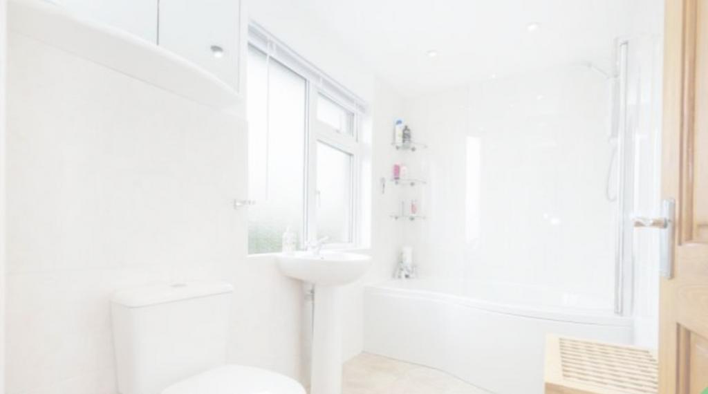 A bright and immaculate bathroom featuring a ba...