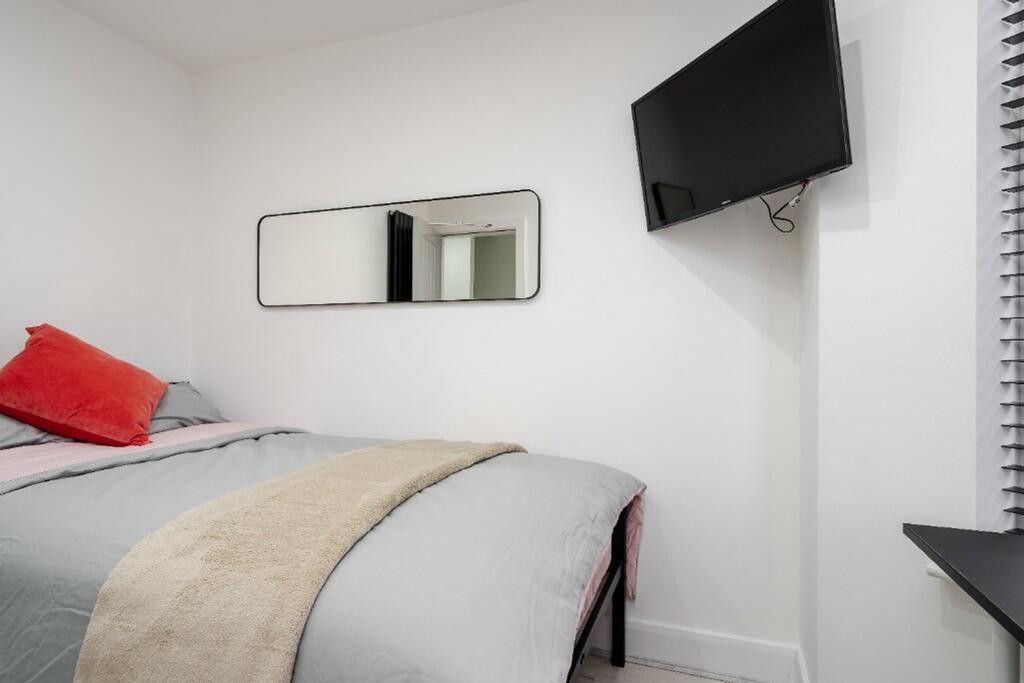 This cozy double bedroom features a comfortable...