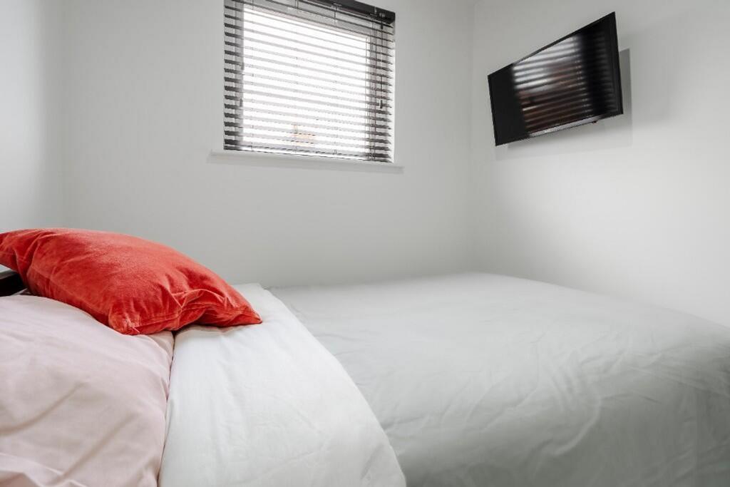 This inviting double bedroom features a cozy la...