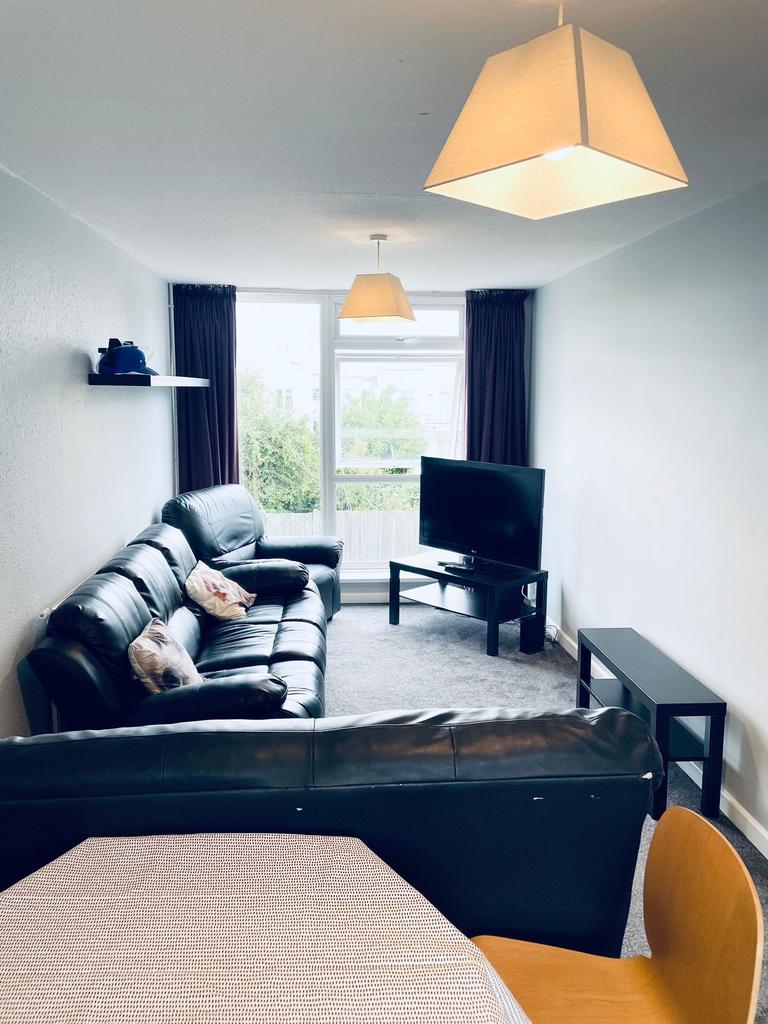 Bright, modern living room with large window an...