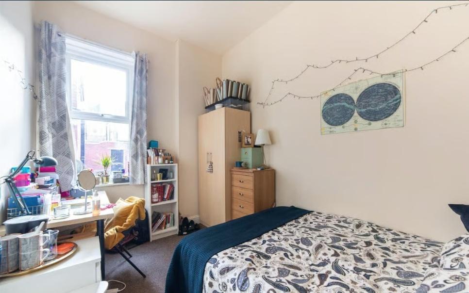 Bright, neatly arranged double bedroom with a p...