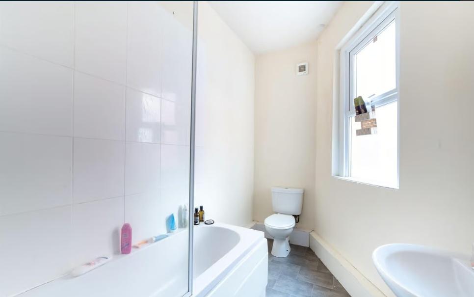 Bright, clean bathroom with a full bath and sho...