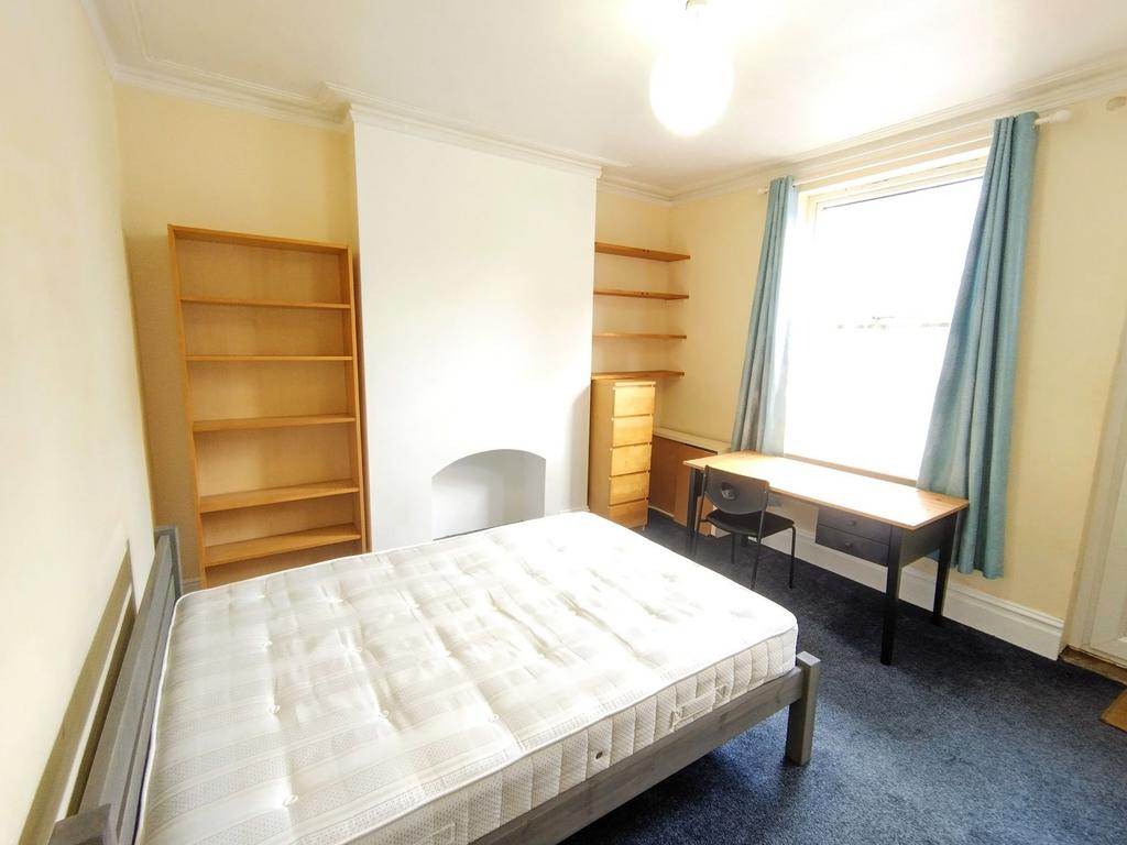Bright furnished bedroom with a double bed, lar...