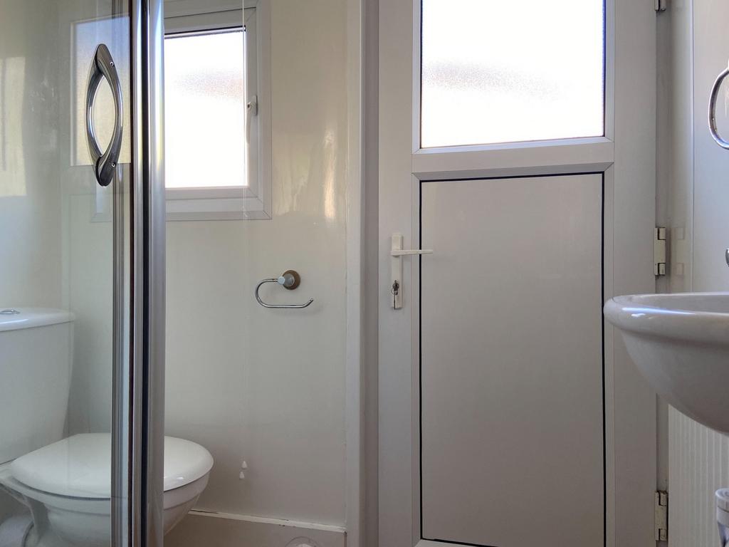 Bright, well-kept bathroom featuring a walk-in ...