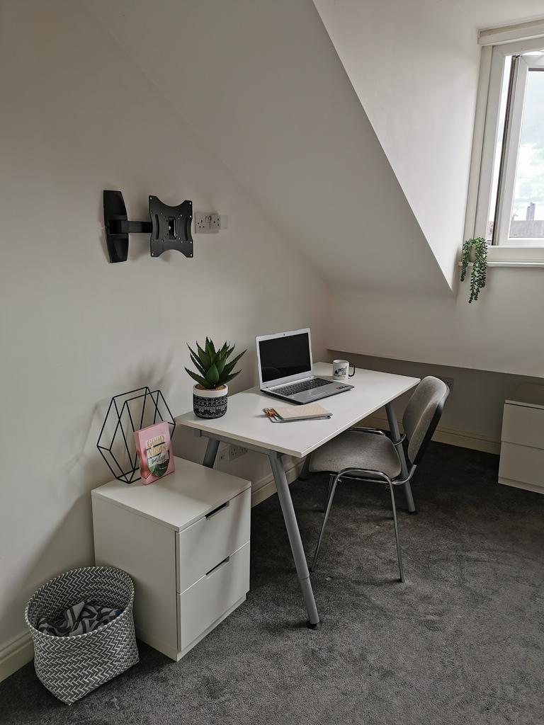 Bright, neatly-styled study corner with a white...