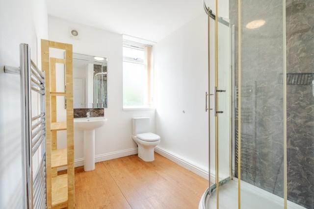 A clean and well-lit bathroom featuring a spaci...