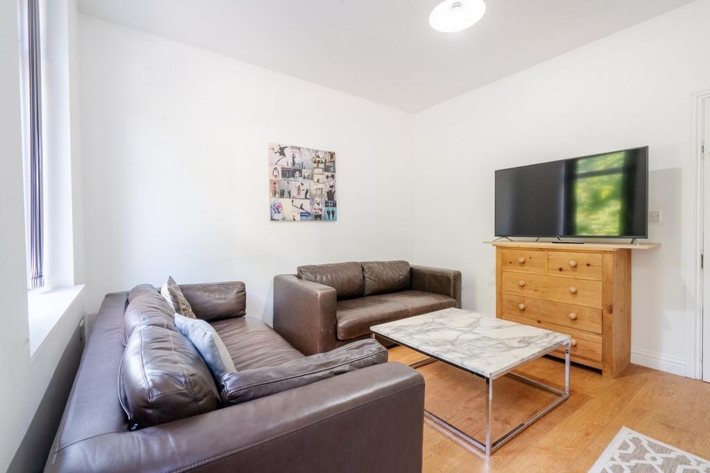 A bright and inviting living room featuring two...