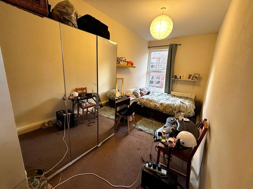 Well-lit double bedroom with a comfy bed by a l...