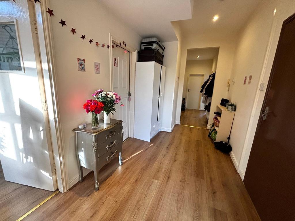 Bright, welcoming hallway with wood-effect floo...