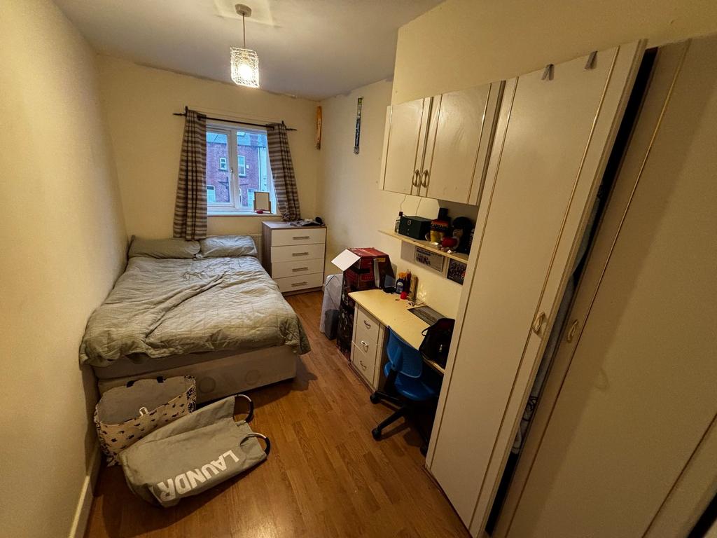 Neat double bedroom with a comfortable bed, bui...