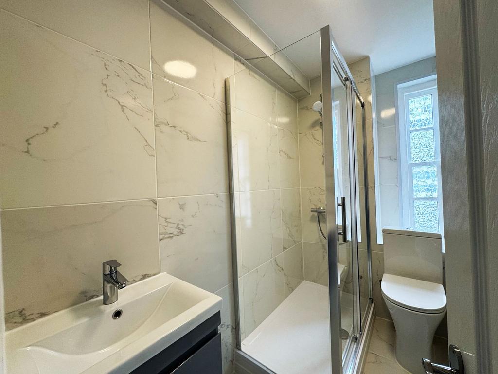 Bright, modern bathroom with a walk-in shower, ...