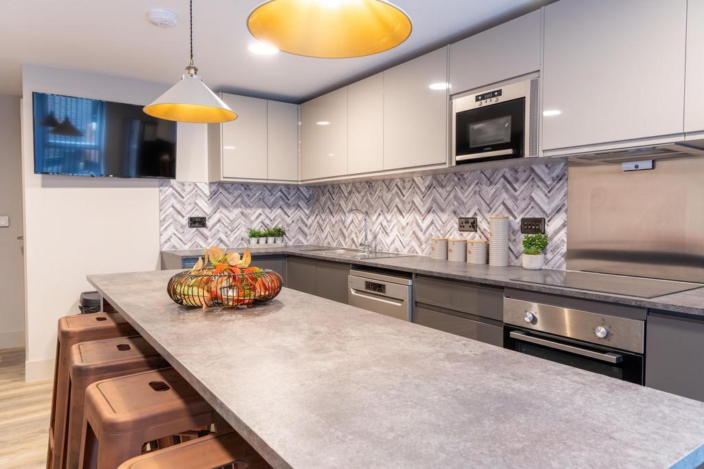 Modern, well-equipped kitchen with a long break...
