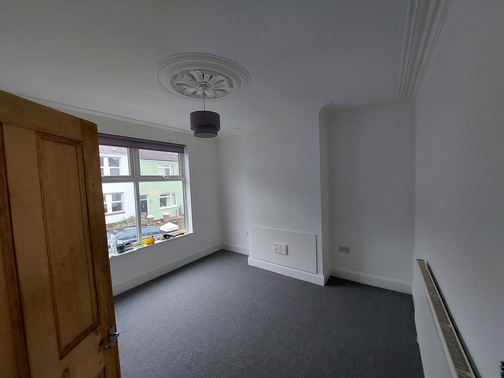 Bright, freshly painted bedroom with a large fr...