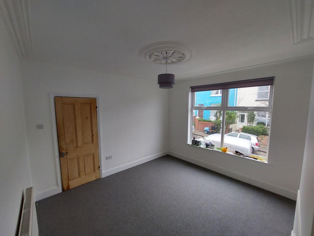 Bright, freshly painted bedroom with large fron...