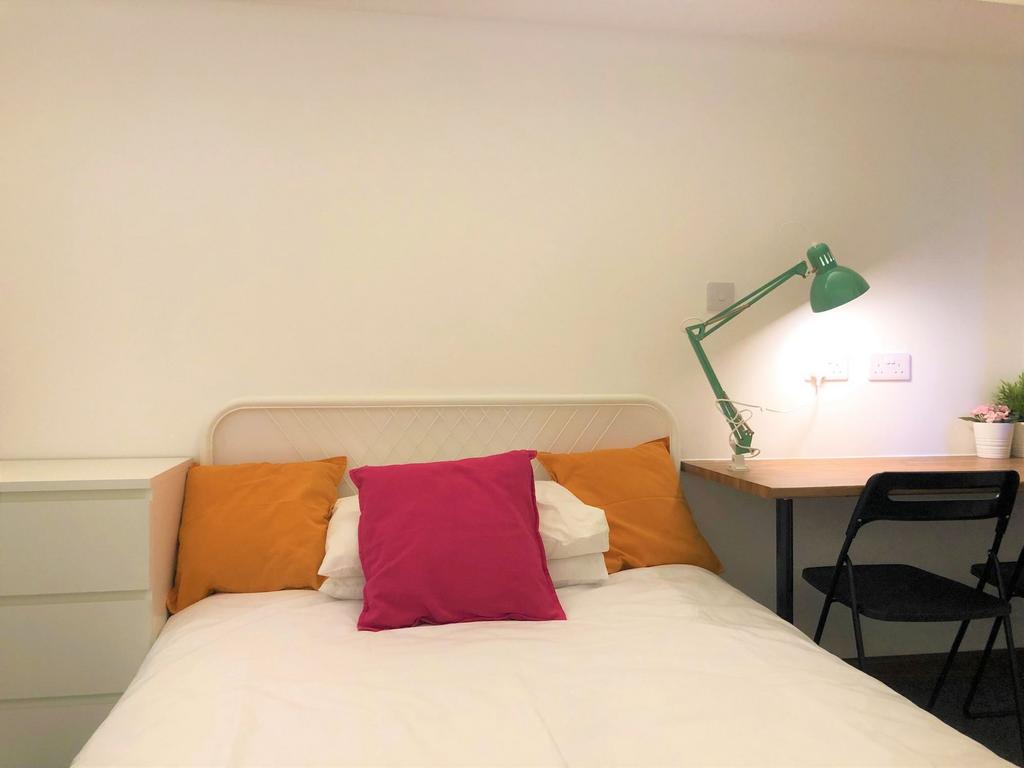 Bright and tidy single bedroom featuring a neat...