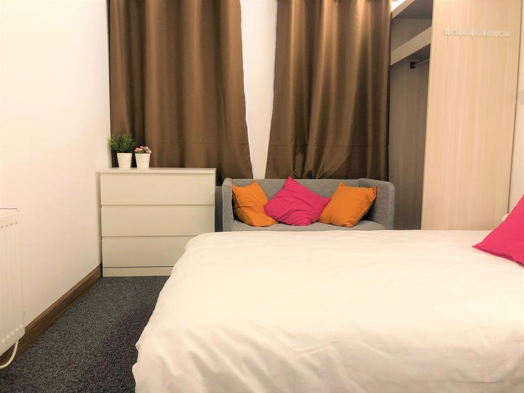 A cozy double bedroom featuring a comfortable w...