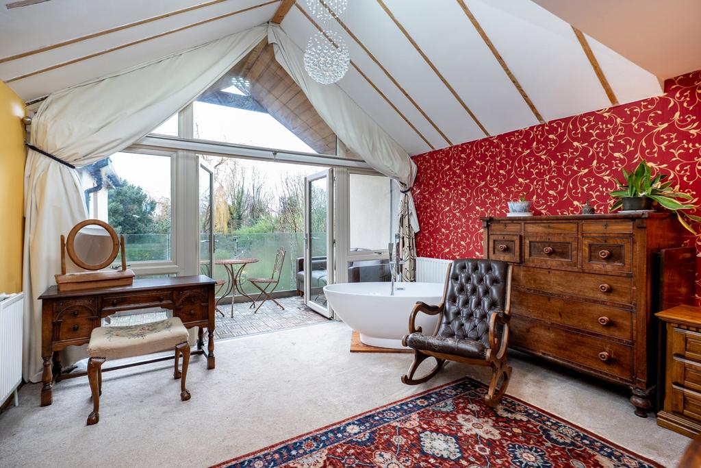 A luxurious main bedroom with private balcony walk