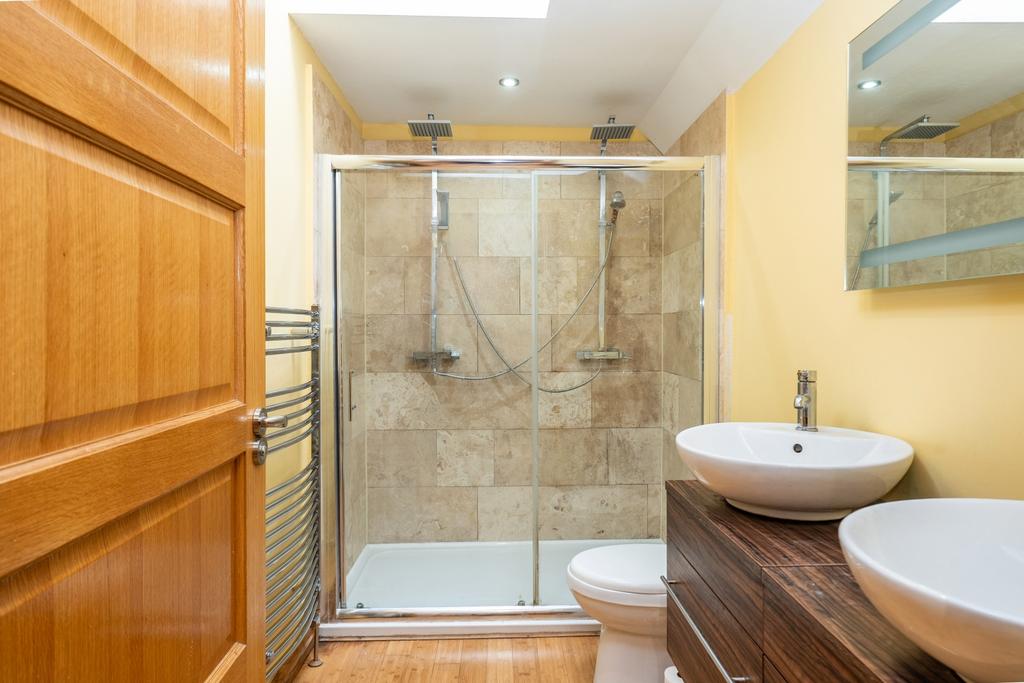 A luxurious ensuite with side by side sinks and a