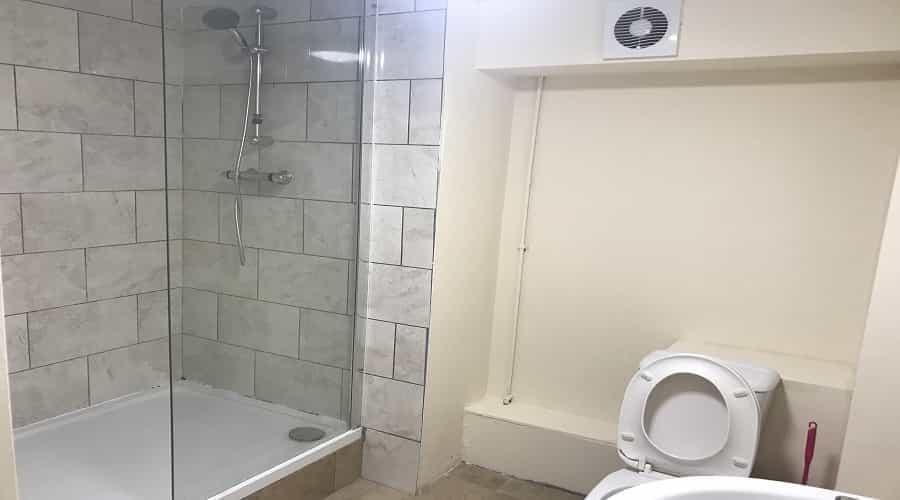 Modern and clean bathroom with a shower enclosu...