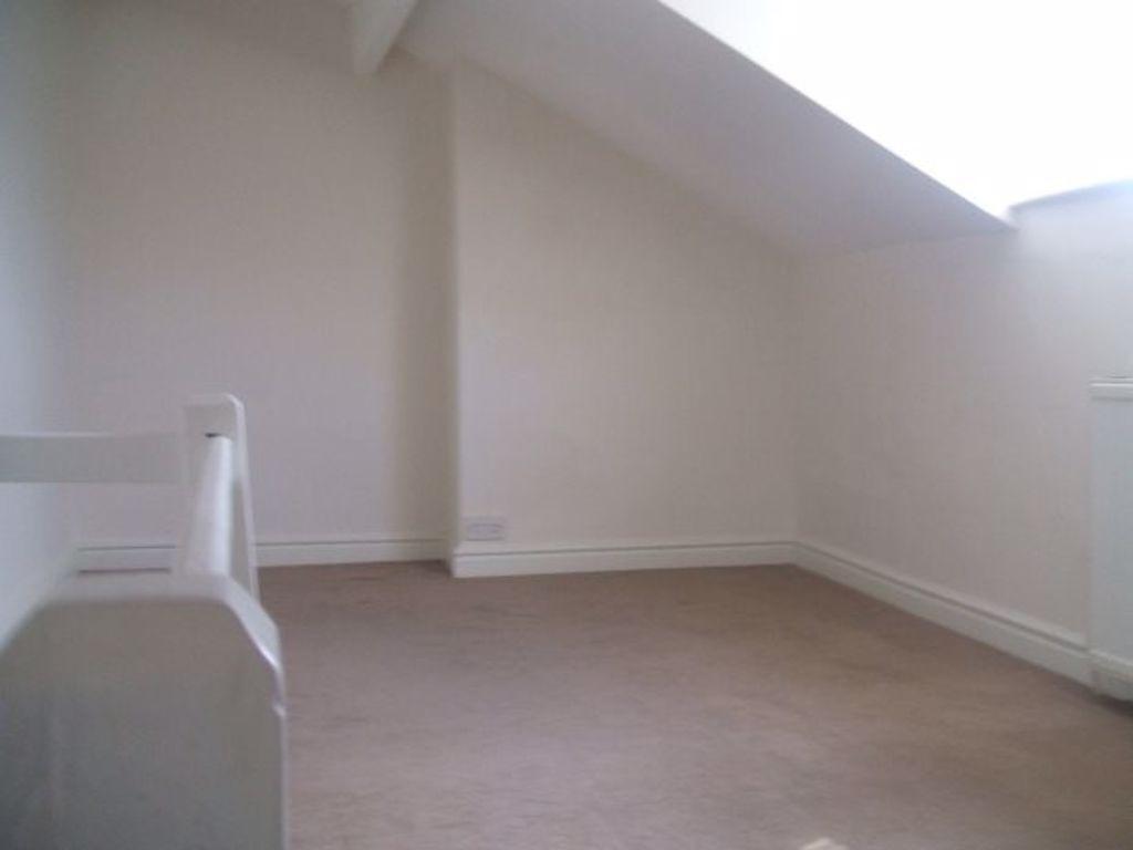 Bright attic-style single bedroom with neutral ...