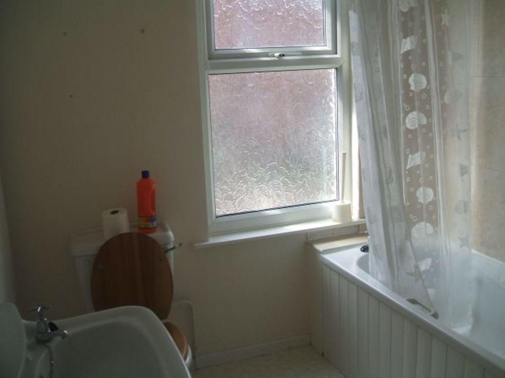Bright bathroom with a bathtub, shower curtain ...