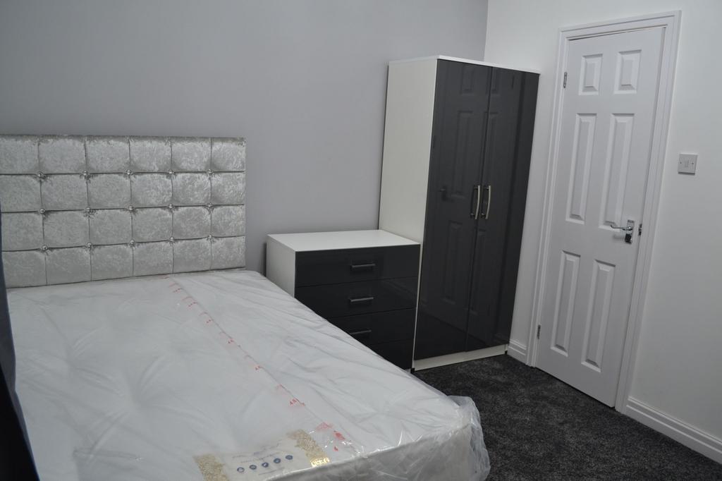 Bright and modern bedroom featuring a plush, tu...