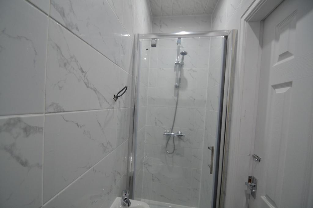 A clean, modern bathroom featuring a white marb...