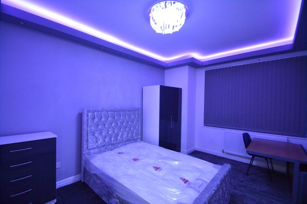 A spacious master bedroom featuring a luxurious...