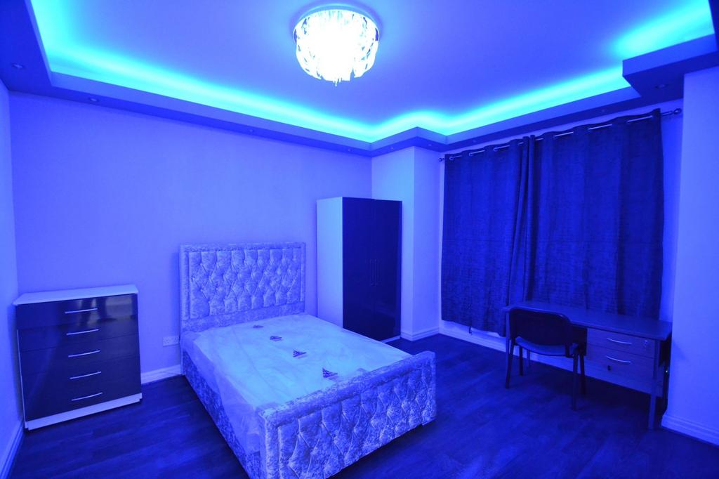 Spacious and modern bedroom featuring a plush u...