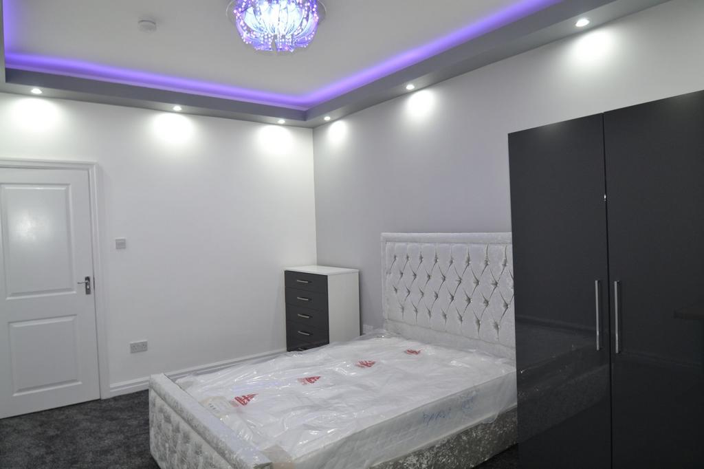 Modern double bedroom with a plush upholstered ...