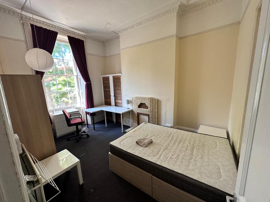 Bright, well-proportioned bedroom with high cei...
