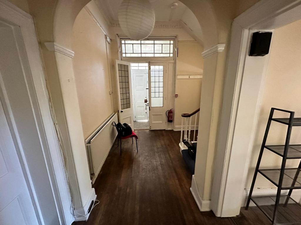 Bright entrance hallway with high ceilings, dec...