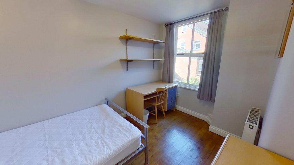 Bright, tidy bedroom with a single bed, wooden ...