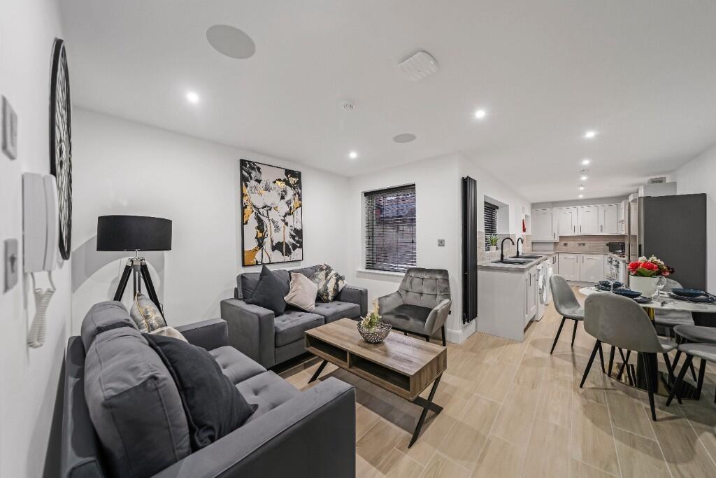 A modern, well-lit living room with stylish fur...