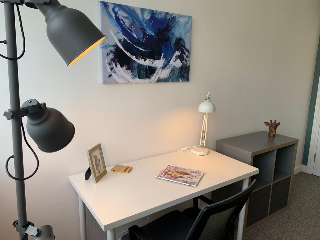 Bright, tidy study corner with a clean white de...