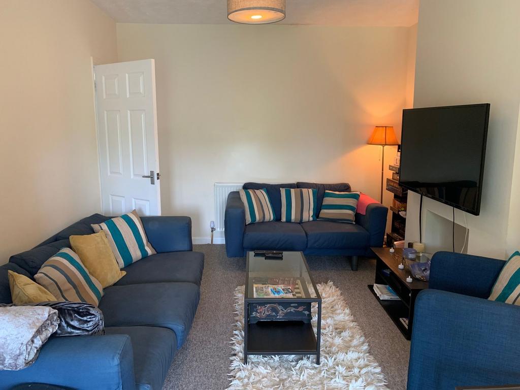Bright, cosy living room with matching blue sof...