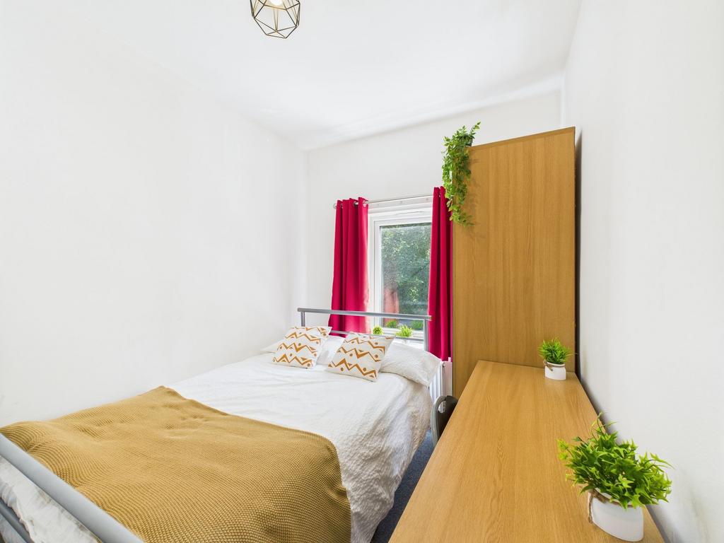 Bright and inviting bedroom featuring a comfort...