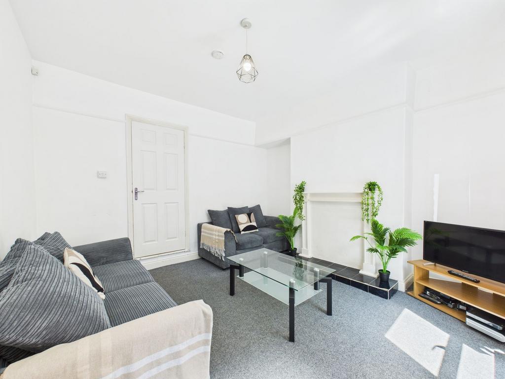 Bright and spacious living room featuring conte...