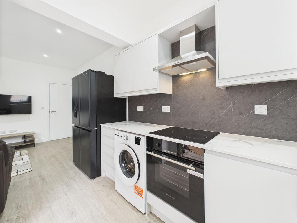 Modern and bright kitchen featuring sleek white...