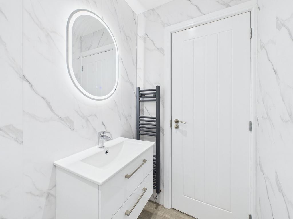 Modern and sleek bathroom featuring a well-lit ...