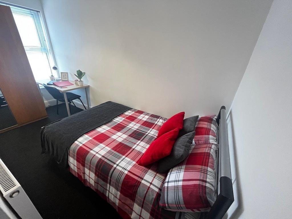 Bright, tidy bedroom with a double bed dressed ...
