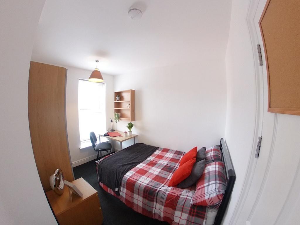 Bright, tidy double bedroom with a patterned re...