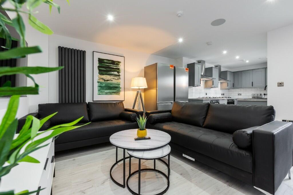 A modern and spacious living room featuring com...