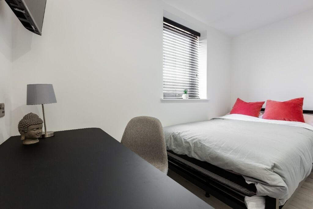 A bright and spacious master bedroom featuring ...