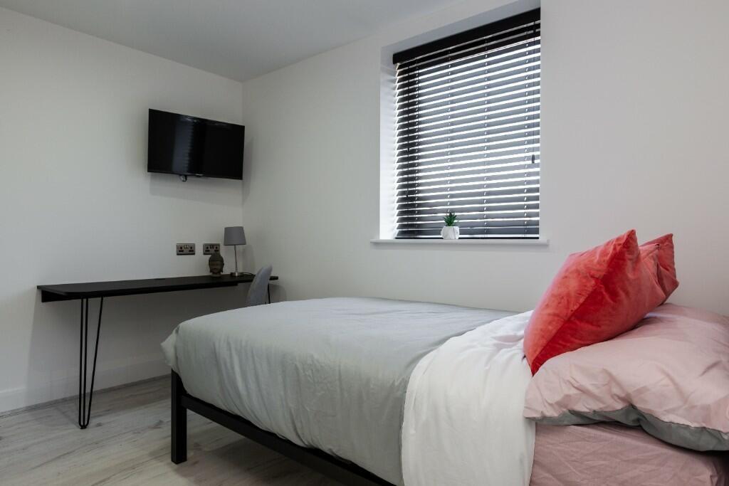 A well-maintained master bedroom featuring a co...