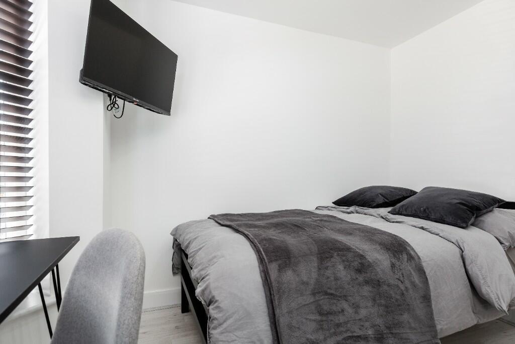 A modern, well-maintained bedroom featuring a d...