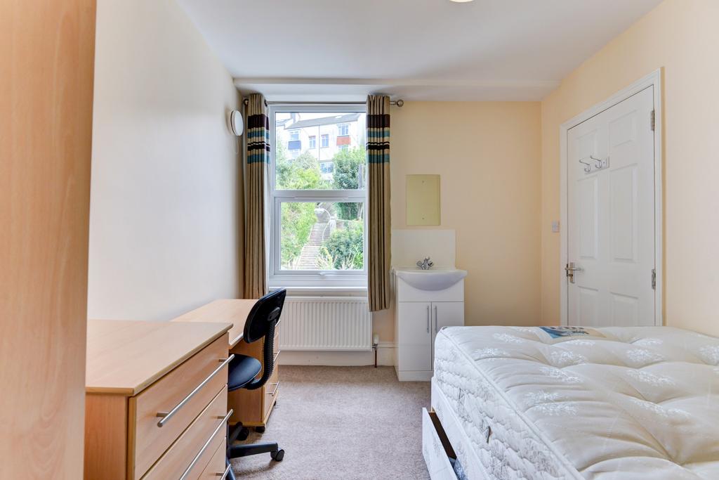 Bright, neatly presented bedroom with a large w...